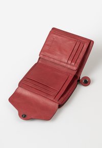 Red leather wallet with several card slots, a coin pocket, and a zipper closure. The interior features a smooth texture and subtle embossed branding.