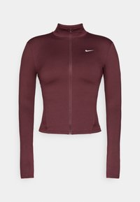 Burgundi színű sportos zipzáras dzseki magas gallérral, hosszú ujjaival és testhezálló fazonnal. A bal felső oldalon egy kicsi fehér Nike logó található.