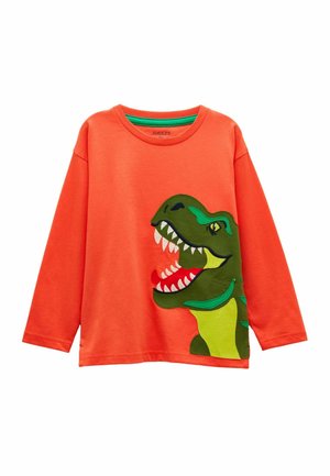 Oranje kindertrui met lange mouwen met een grote groene en gele cartoon-dinosauruskop aan de voorkant, met een open mond en scherpe tanden.