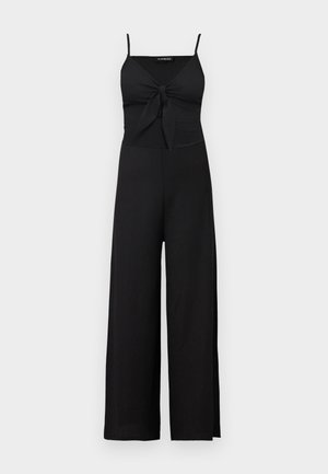 Crni kombinezon bez rukava s širokim nogavicama i detaljem svezivanja sprijeda na V-izreza na tankim naramenicama.
