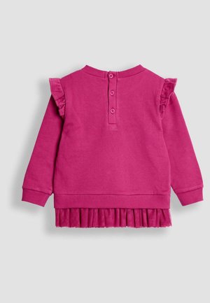 Rosa Sweatshirt mit einem Volant-Design an den Ärmeln und einem gepufften Saum. Es hat einen runden Ausschnitt und drei Knöpfe auf der Rückseite.