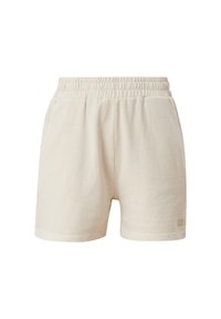 Béžové bavlněné šortky s elastickým pasem, vybavené dvěma bočními kapsami a minimalistickým brandingem na dolním okraji. Měkká textura, volný design.