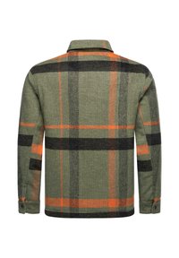 Green plaid flannel shirt with orange and black patterns. Features a collared neck and buttoned cuffs. Textured fabric with a warm appearance.