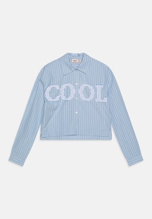 Cropped blue striped shirt with long sleeves and button closure. Features large "COOL" lettering in white across the front.
