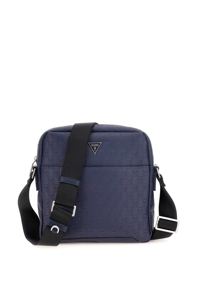 Sac bandoulière synthétique bleu marine avec texture géométrique, doté d'un emblème logo, d'une sangle noire ajustable et de accents en métal argenté.