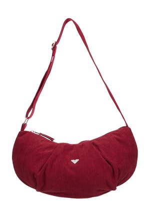 Small curved shoulder bag in red corduroy fabric with adjustable strap and silver zipper on top.