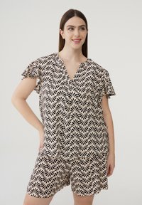 Completo con top a maniche corte e scollatura a V e pantaloni corti in beige con motivo foglia nera; tessuto leggero; vestibilità comoda; orli delle maniche arricciati.
