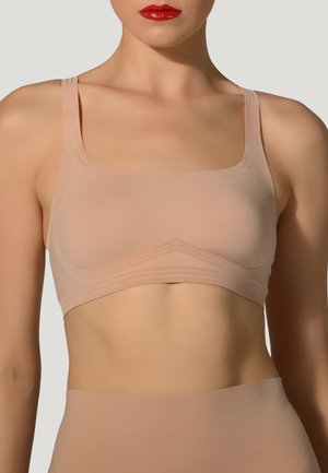 Lys beige bralette med firkantet halsudskæring, tynde stropper og subtil ribbet detaljering langs kanten. Glat, strækbart stof.