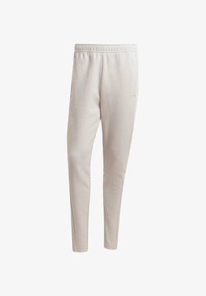 Vaaleanbeige jogger-housut, jotka on valmistettu pehmeästä kankaasta. Ne on varustettu joustavalla vyötäröllä, sivutaskuilla ja kapenevalla lahkeella.