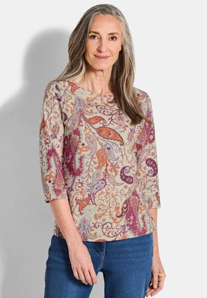 Langärmliges, gemustertes Oberteil mit Paisley-Design in sanften Beige-, Lila- und Orangetönen. Besitzt einen runden Halsausschnitt und eine lockere Passform.