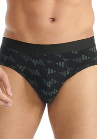 Čern�é boxerky s geometrickým vzorem ve tmavě zelené, měkké tkanině a hladkým pasem. Přední šev pro lepší pohodlí.