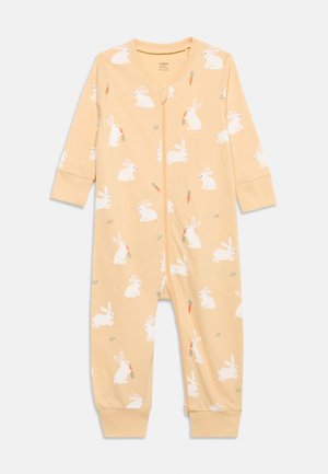 Helebeežide beebikombekas valgete jäneste ja porgandi trükkidega, pikkade varrukatega, esiküljel tõmblukuga ning varrukate ja säärte otsas kummiribadega.