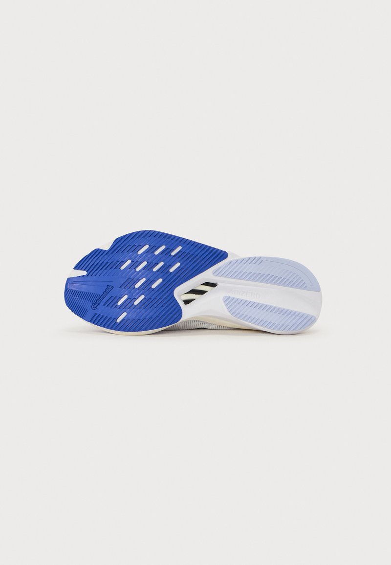Suola della scarpa in blu e bianco, con un motivo testurizzato e scanalature per la presa. Design leggero e flessibile per prestazioni migliorate.