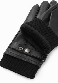 Gants en cuir noir avec des poignets en tricot et un revêtement doux en fourrure, comportant une sangle avec des boutons-pression en métal sur un fond blanc.