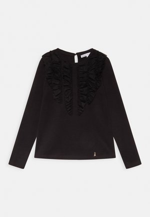 Sort bluse med lange ærmer med flæser på vertikale paneler foran og en lille gylden broderet myre nær kanten.