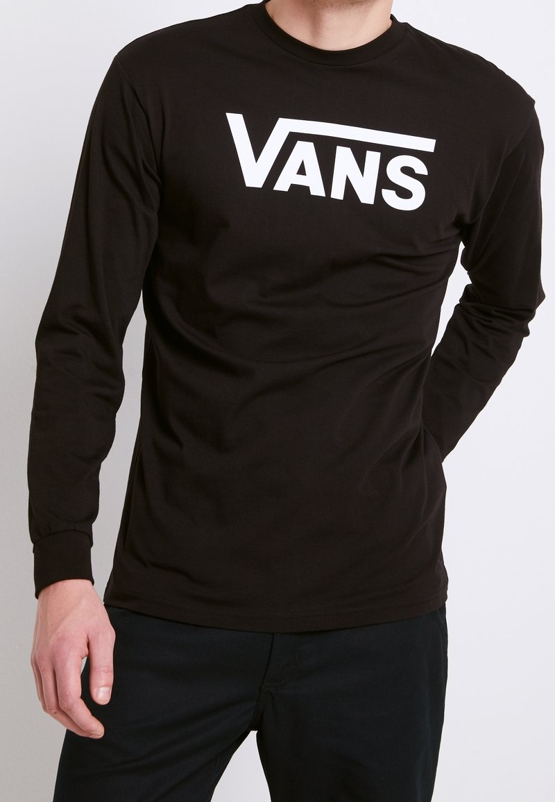 T-shirt a maniche lunghe in cotone nero con un grande logo bianco "VANS" sulla parte frontale. Design aderente con polsini a coste e scollatura a girocollo.