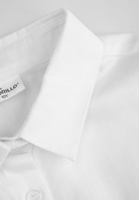 Biała bawełniana koszula z kołnierzykiem, z widocznym szwem i wszytą metką wewnątrz dekoltu.