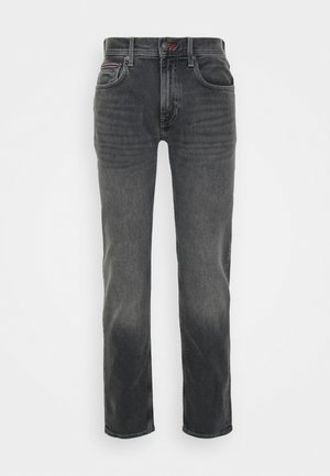 Jeans in denim grigio scuro con design a cinque tasche, chiusura con bottone e leggere sfumature sulle cosce e sulle ginocchia.