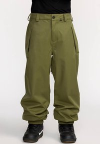 Grüne Skihose mit lockerem Schnitt, seitlichen Reißverschlusstaschen, elastischen Bündchen und Knopfverschluss an der Taille. Hergestellt aus langlebigem Material.