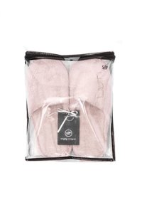 Pink fluffy slippers in a transparent packaging with a black zipper. Size S/M tag attached, featuring soft texture and subtle logo detail.