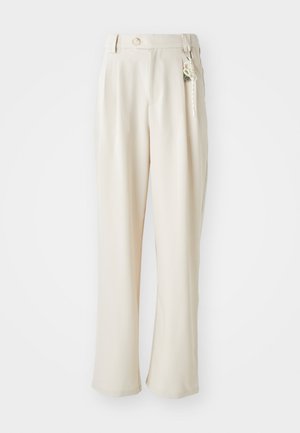 Beige wide-leg trousers with a high waist, single button closure, pleated front, and decorative keychain accent. Smooth, lightweight fabric.