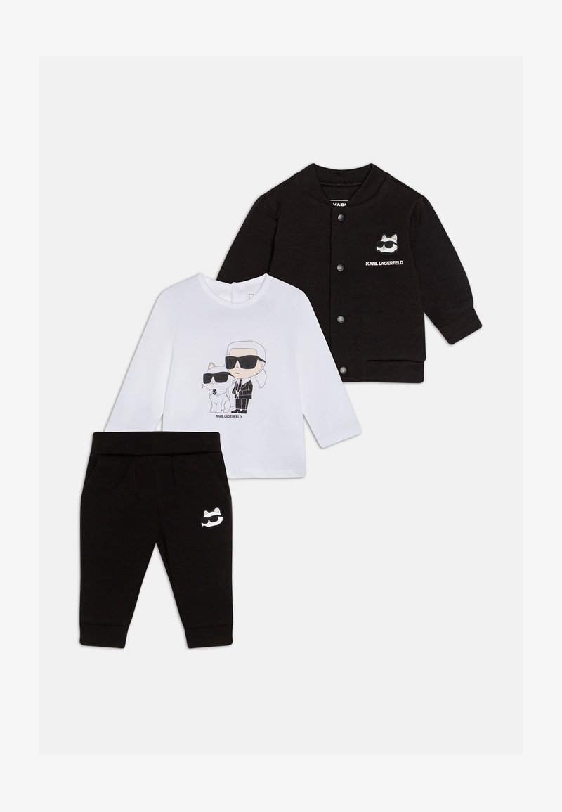 Ensemble pour enfants noir et blanc comprenant une chemise blanche à manches longues avec impression graphique, un cardigan noir et un pantalon noir avec un logo de chat.