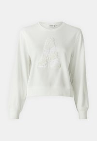 Bílá zkrácená mikina s dlouhými rukávy, se strukturálním "A" vyrobeným z flitrů a měkké tkaniny. Jednoduchý kulatý výstřih.