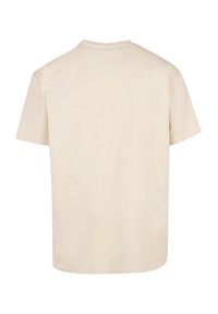 Beige cotton t-shirt with a crew neckline, short sleeves, and a relaxed fit. The back view shows a plain design with no visible graphics.