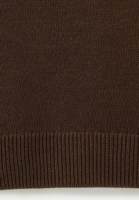 Close-up of dark brown knitted fabric with a ribbed hem at the bottom, showing detailed knit texture and stitch pattern.