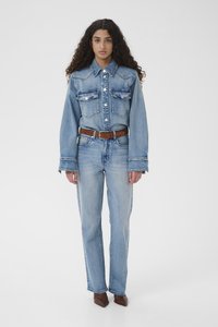 Denimjakke og jeans i lyseblå, med knappelukking, to brystlommer og brun belte. Tettsittende, med vide mansjetter.