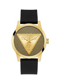 Montre dorée avec un design en maille triangulaire, dotée d'un bracelet en silicone noir et d'un logo triangulaire proéminent sur le cadran.