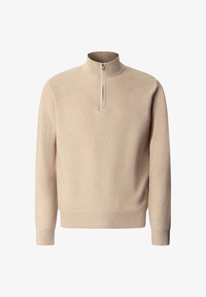 Beiger Strickpullover mit langen Ärmeln und kurzem Frontreißverschluss, der vom Kragen bis zur Brust reicht.