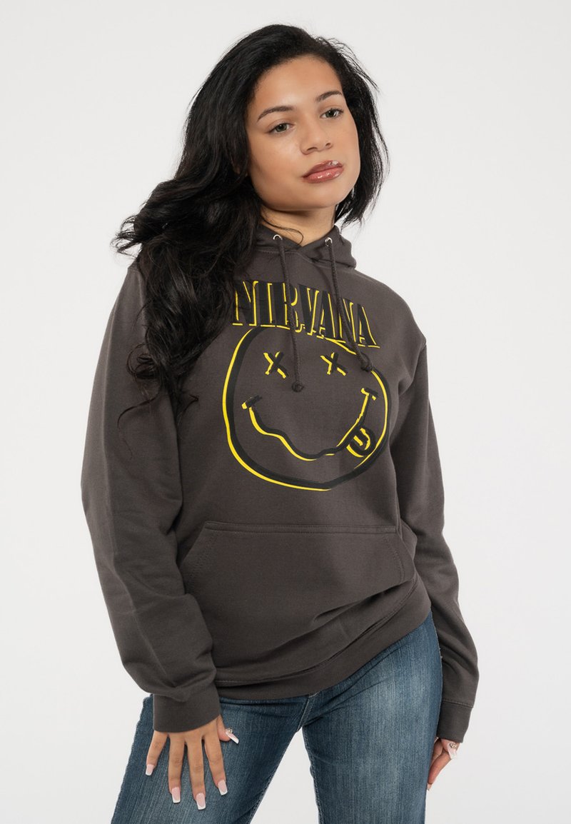 Dark gray hoodie made of cotton blend, features yellow Nirvana logo and smiley face graphic, with a front pocket and drawstring hood.