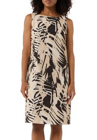 Ärmelloses Kleid mit beigem Grundton und auffälligen schwarzen und cremefarbenen abstrakten Palmblattmustern, schrägem Schnitt und knie-langer Form.