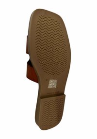 Suela de sandalia de goma marrón con textura de patrón de olas. Talla 37, marcada con símbolos de cuidado y "HECHO EN ESPAÑA" en la parte inferior.