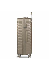 Hard-shell suitcase in metallic bronze with ribbed texture, retractable handle, combination lock, and four wheels for maneuverability.