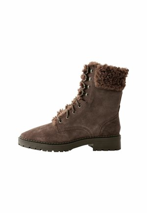 Brown suede ankle boot with a textured faux fur cuff, lace-up design, metal eyelets, and a rugged sole for traction.