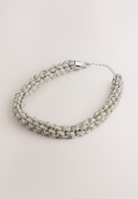 Metallic woven necklace featuring silver and light gray beads, secured with silver-tone ends and a chain clasp for adjustable fit.