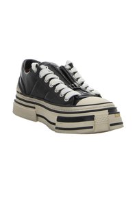 Schwarze Ledersneaker mit dicker beigefarbener Sohle, ausgestattet mit einem Reißverschluss und weißen Schnürsenkeln, akzentuiert durch dunkle Streifen entlang der Sohle.