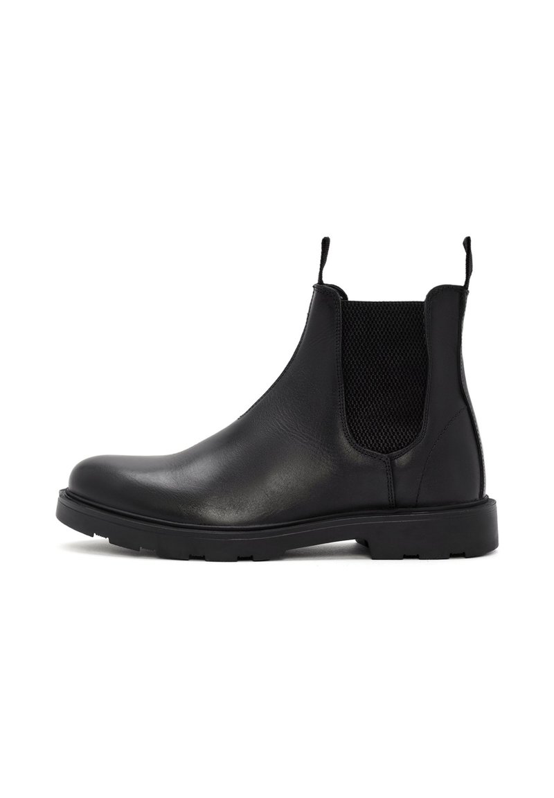 Botines Chelsea de cuero negro con paneles laterales elásticos, tiradores y una suela resistente. Textura suave con un diseño elegante y moderno.