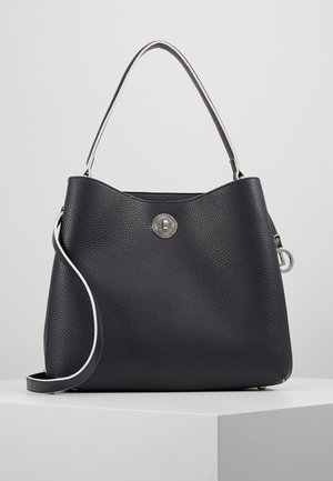 Black textured leather handbag with silver turn-lock clasp, single top handle, and detachable shoulder strap, placed on white surface.