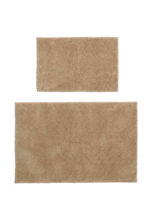 Two rectangular beige bath rugs, one smaller placed above a larger one, both with a soft, plush texture on a white background.