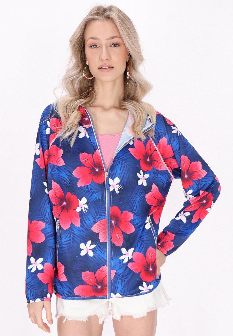 Blommig zip-up jacka i mörkblått med ljusröda hibiskusar och vita blommönster. Lättviktig tyg med långa ärmar och elastiska manschetter.