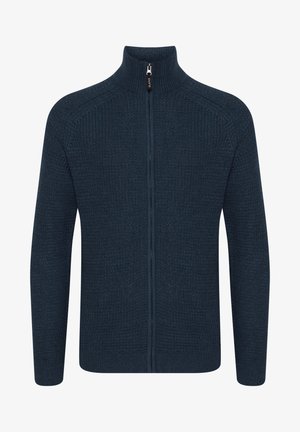 Pull en maille bleu marine avec zip et col montant, texture côtelée et manches longues, doté d'une fermeture éclair à l'avant et d'un design épuré.