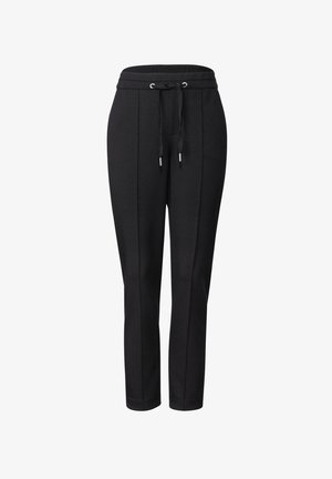 Schwarze Jogginghosen mit einem Kordelzug am Bund, schmal zulaufenden Beinen und flachen Vordernähten. Hergestellt aus einem weichen, dehnbaren Material. Keine sichtbaren Taschen.