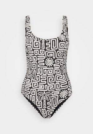 Valkoinen ja musta yksi osainen uimapuku, jossa on geometrinen kuvio, joka sisältää spiraaleja ja palmu-designteja. Leveät hihnat ja pyöreä pääntie.