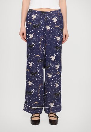 Blue pajama pants featuring a celestial pattern with unicorns, stars, and moons; elastic waistband, wide-leg design, with a contrasting trim detail.