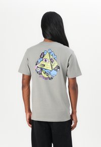 Gray cotton t-shirt featuring a colorful graphic design on the back, depicting a pyramid, eye, and celestial elements. Short sleeves.