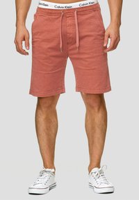 Shorts en coton rose Calvin Klein avec une taille élastique, un cordon de serrage et des poches latérales, présentant une coupe décontractée et une finition à l'ourlet.