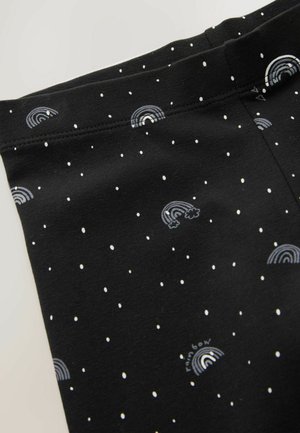 Black fabric features white polka dots and multicolored rainbow patterns. The material appears soft and stretchy, suitable for comfortable wear.